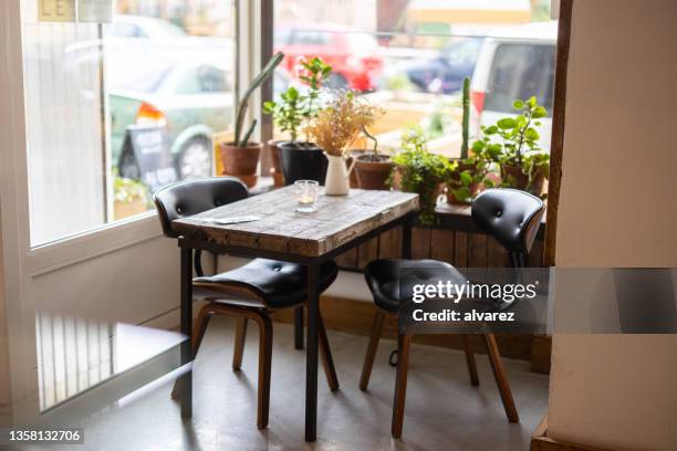 empty modern cafe table by the window - cafeteria table stock pictures, royalty-free photos & images