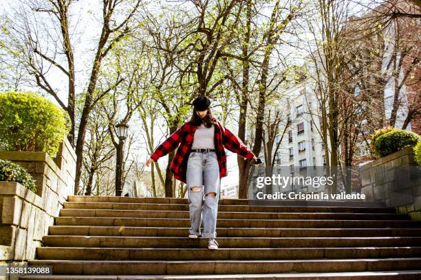 cheerful college girl walking down the stairs of an urban park - look down stock-fotos und bilder