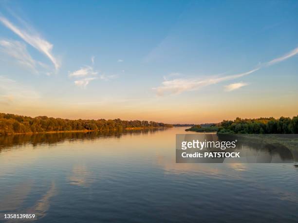 river vistula at sunset seen from józef pisudski's bridge nearby nowy dwor mazowiecki, poland - silesia stock pictures, royalty-free photos & images