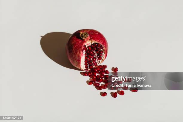 ut pomegranate on a white background. menstruation concept. symbol of vagina. gynecology, female intimate health - temi legati alla sessualità foto e immagini stock