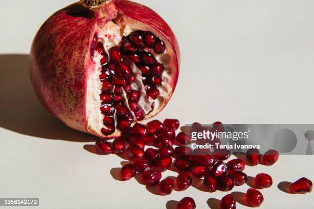 ut pomegranate on a white background. menstruation concept. symbol of vagina. gynecology, female intimate health - pomegranate stock pictures, royalty-free photos & images
