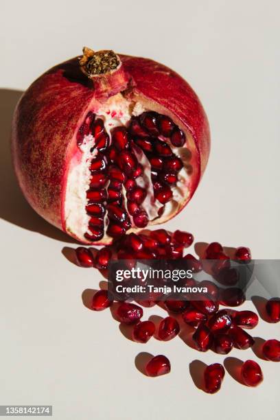 ut pomegranate on a white background. menstruation concept. symbol of vagina. gynecology, female intimate health - pomegranate stock pictures, royalty-free photos & images