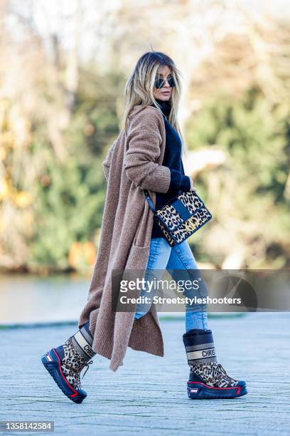 Influencer Gitta Banko, wearing a black pullover by Boscana, a Jeans by AG Jeans, animal printed Moon Boots by Dior, an animal printed bag by Dior, a...