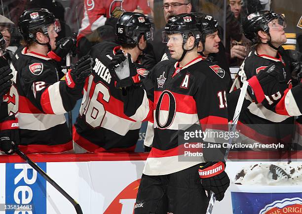 Jason Spezza of the Ottawa Senators celebrates his third period goal against the Boston Bruins with team mates Erik Condra and Bobby Butler of the...