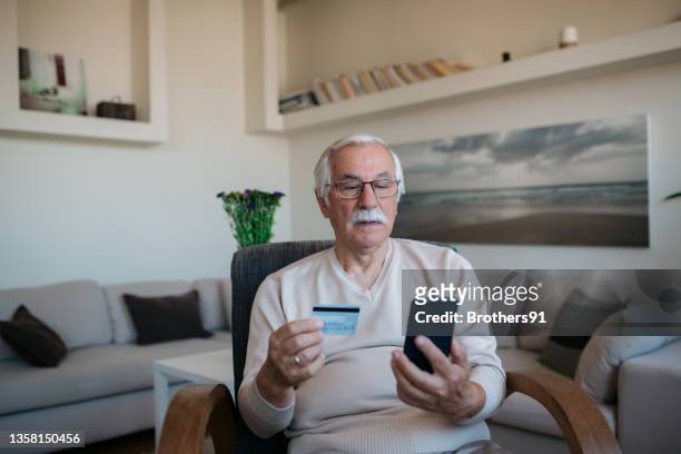 elderly caucasian man shopping online from home - personal data stock pictures, royalty-free photos & images