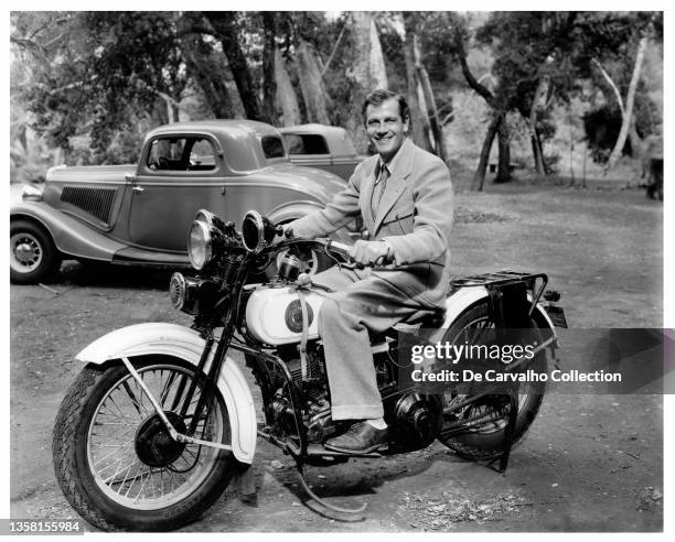 Actor Joel McCrea sits on a California Police Patrol motorcycle in a candid shot taken on the set of the movie 'Our Little Girl' United States.