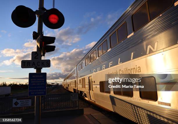 An Amtrak train arrives at a station stop on December 9, 2021 in Burbank, California. Amtrak is having difficulty hiring and retaining employees as a...