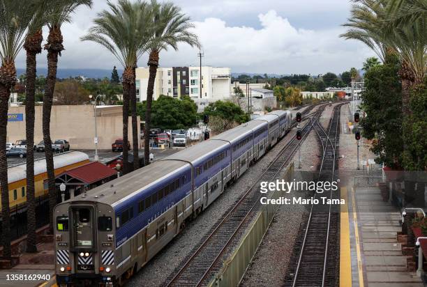 An Amtrak train arrives at a station stop on December 9, 2021 in Fullerton, California. Amtrak is having difficulty hiring and retaining employees as...