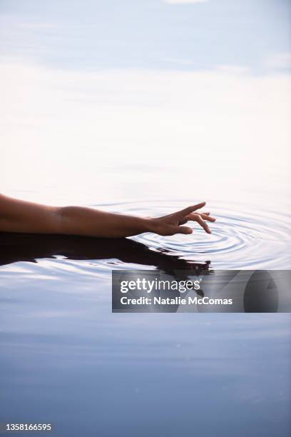 hand and arm silhouette swimming in a lake - calm water stock pictures, royalty-free photos & images