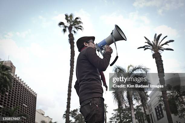 Man chants on speaker on Kasr El Aini Street approaching Tahrir Square on December 2, 2011 in downtown Cairo, Egypt.