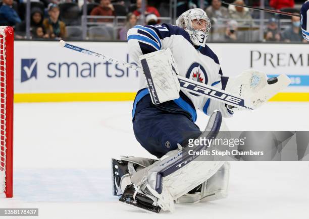 Connor Hellebuyck of the Winnipeg Jets makes a save against the Seattle Kraken during the second period at Climate Pledge Arena on December 09, 2021...