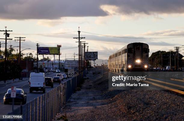 An Amtrak train arrives at a station stop on December 9, 2021 in Burbank, California. Amtrak is having difficulty hiring and retaining employees as a...