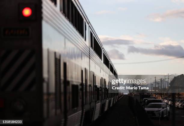 An Amtrak train departs a station stop on December 9, 2021 in Burbank, California. Amtrak is having difficulty hiring and retaining employees as a...