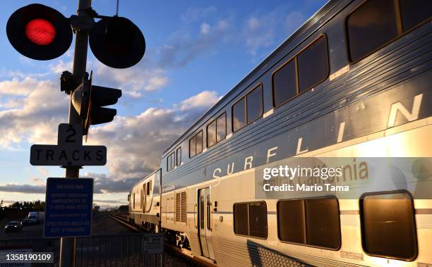 An Amtrak train arrives at a station stop on December 9, 2021 in Burbank, California. Amtrak is having difficulty hiring and retaining employees as a...