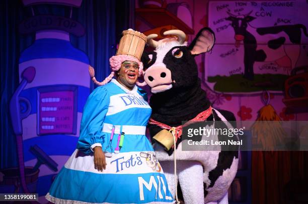 Dame Trot", played by Clive Rowe, speaks with a traditional pantomime cow during an evening performance of "Jack and The Beanstalk" pantomime at the...