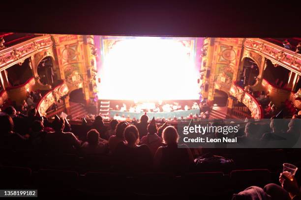 Audience members watch an evening performance of "Jack and The Beanstalk" pantomime at the Hackney Empire on December 09, 2021 in the London Borough...