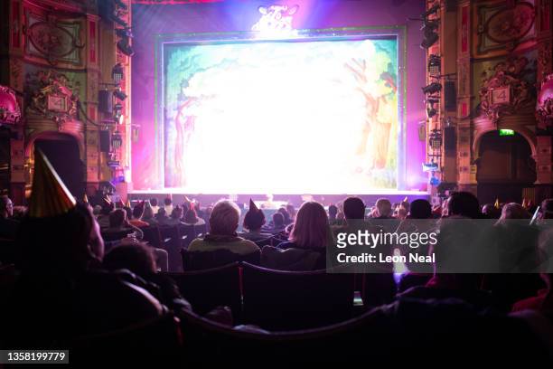 Audience members watch an evening performance of "Jack and The Beanstalk" pantomime at the Hackney Empire on December 09, 2021 in the London Borough...