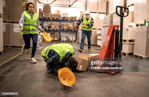 warehouse worker after an accident in a warehouse - crash stock pictures, royalty-free photos & images