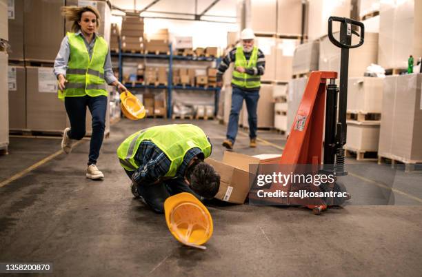 warehouse worker after an accident in a warehouse - crash imagens e fotografias de stock