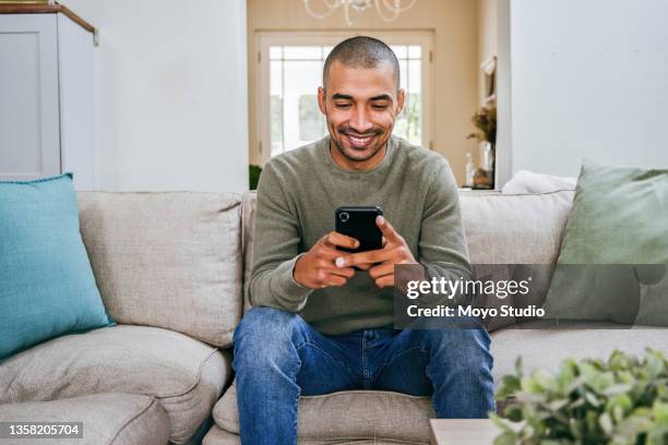 shot of a handsome young man using his smartphone to send a text message - one mid adult man only bildbanksfoton och bilder