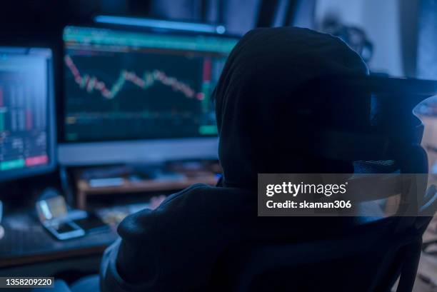 back angle hacker wearing hoodies cloth motivation emotion and typing coding to hacking cryptocurrency from internet  at home - hack stock pictures, royalty-free photos & images