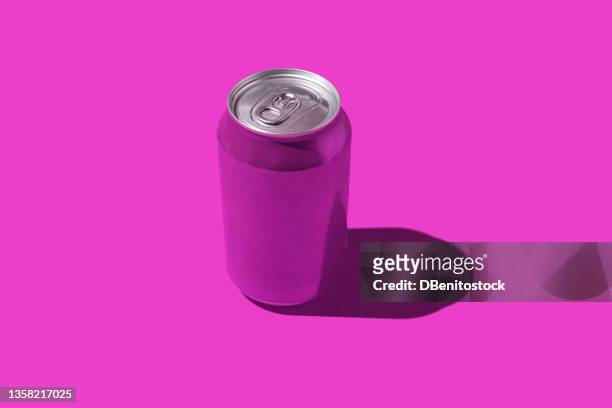 purple soda can with hard shadow, on purple background. - soda bottle - fotografias e filmes do acervo