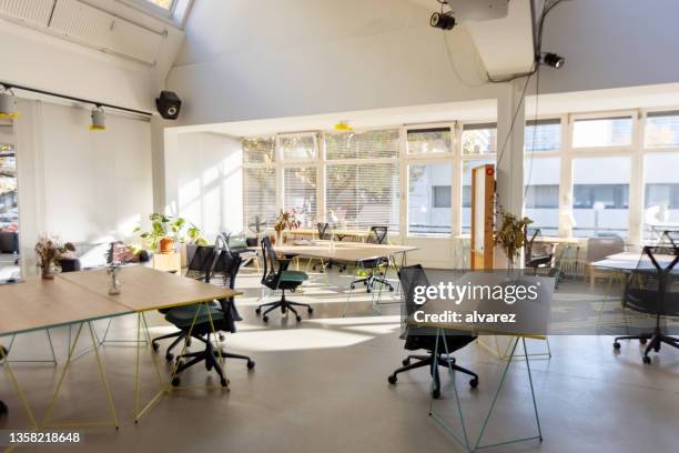 brightly lit empty startup office interior - bureau en open space stockfoto's en -beelden