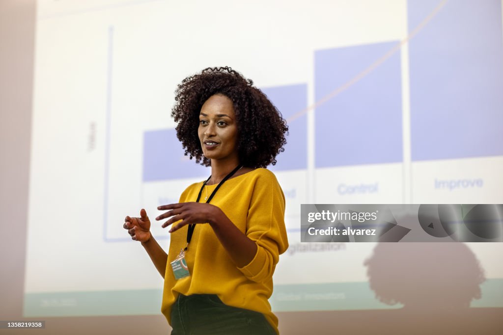 Woman entrepreneur at seminar giving presentation