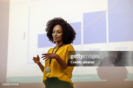 Woman entrepreneur at seminar giving presentation Woman entrepreneur at seminar giving presentation