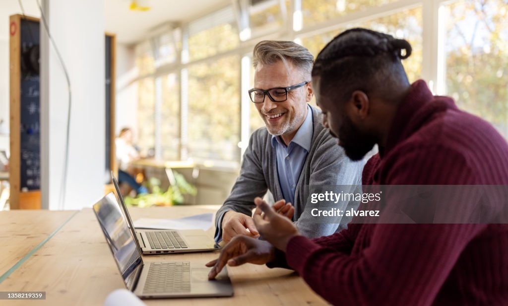 Business professionals discussing work in startup office