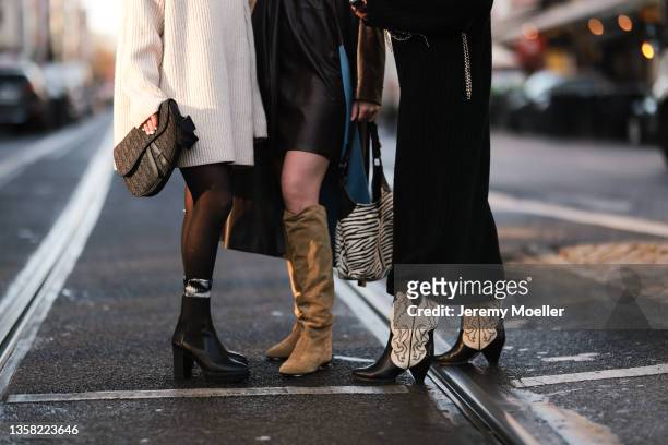 Hannah Löhr, Johanna Löer and Henni wearing Cph803 Vitello black boots, beige H&M sweater, Drykorn brown leather dress and brown leather coat, Prada...