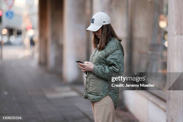Johanna Löer wearing Closed beige pants, Zara olive jacket, New Era cap on December 07, 2021 in Cologne, Germany.