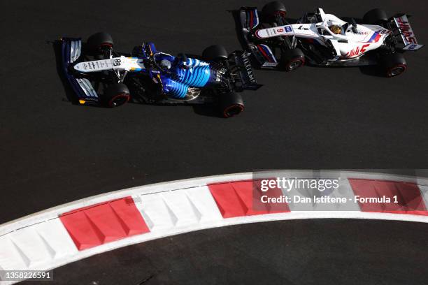 Jack Aitken of Great Britain driving the Williams Racing FW43 Mercedes leads Nikita Mazepin of Russia driving the Haas F1 Team VF-21 Ferrari during...