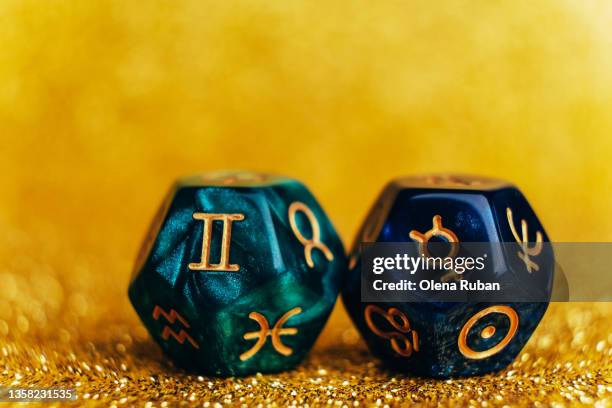 glowing green and blue divination dice gemini and mercury. - sterrenbeeld tweelingen stockfoto's en -beelden