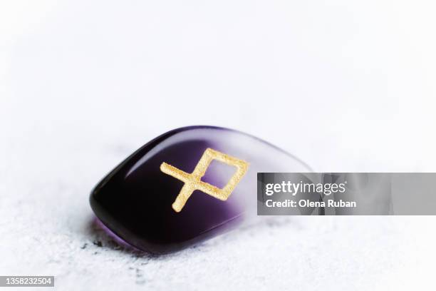 one purple-white divination stone rune. - visual tricks stock pictures, royalty-free photos & images