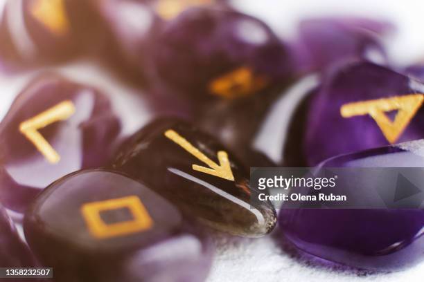 purple divination stone runes on white background. - medium group of objects - fotografias e filmes do acervo