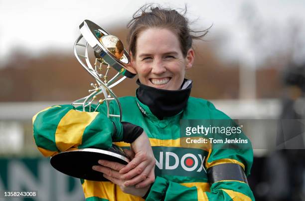 Rachael Blackmore celebrates with the trophy after victory on Minella Times in the Grand National on day three of the Aintree Grand National racing...