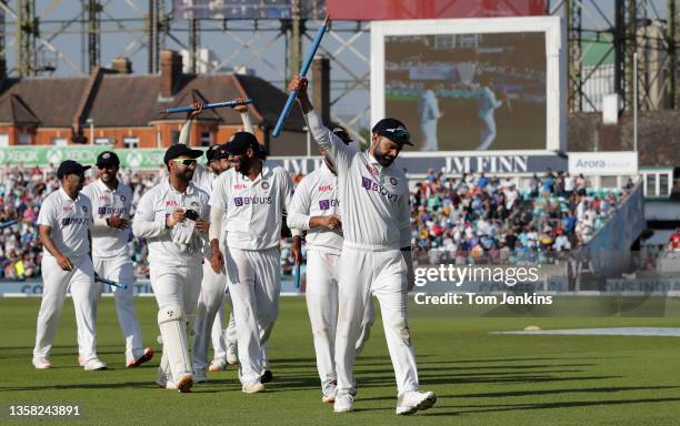 Indian captain Virat Kholi celebrates as he leads his victorious team off at the end during day five of the England v India 4th test match at the Kia...