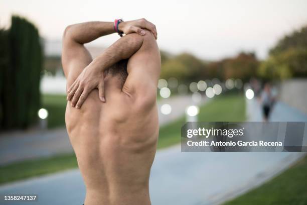 man training fotness and running in public city park - men wearing bras photos stock pictures, royalty-free photos & images