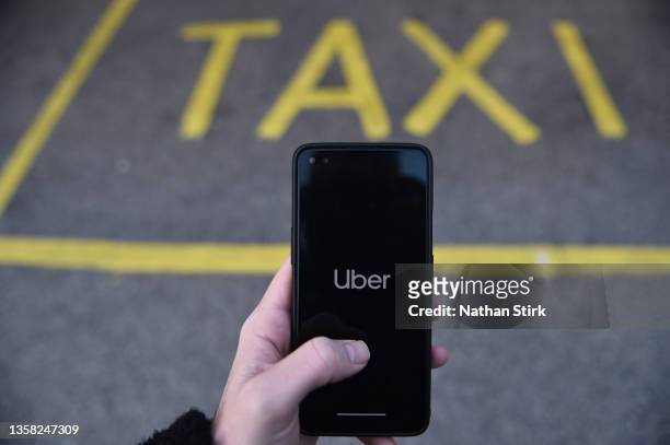 Phone is held displaying the Uber app on December 10, 2021 in Stoke on Trent, England.