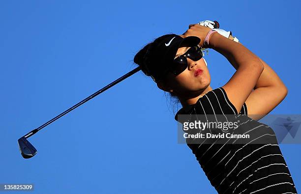 Michelle Wie of the USA tees off from the tee on the par 3, 4th hole during the second round of the 2011 Omega Dubai Ladies Masters on the Majilis...