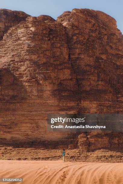 woman traveler walking the picturesque remote desert enjoying the view at wadi rum - hot middle eastern women stock pictures, royalty-free photos & images