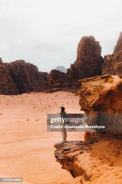 woman traveler contemplating the scenic mountain view of wadi rum desert from above - hot middle eastern women stock pictures, royalty-free photos & images