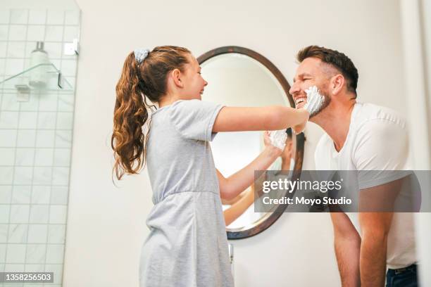 shot of a father teaching his daughter how to shave his face at home - girl shaving stock pictures, royalty-free photos & images