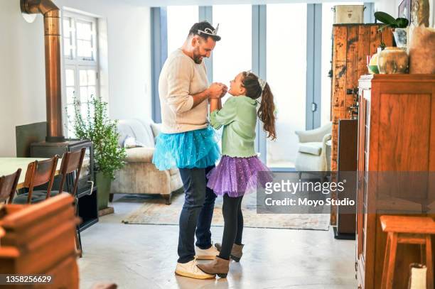 shot of a father and daughter practicing a dance routine together at home - royalty free space images stockfoto's en -beelden