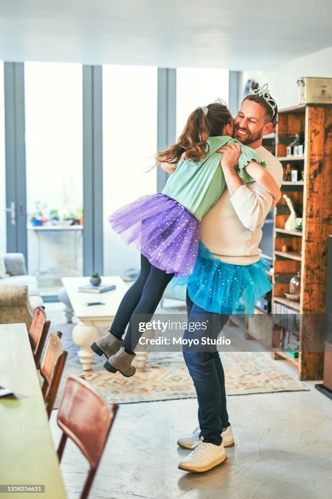 Shot of a father and daughter embracing while practicing a dance routine together at home