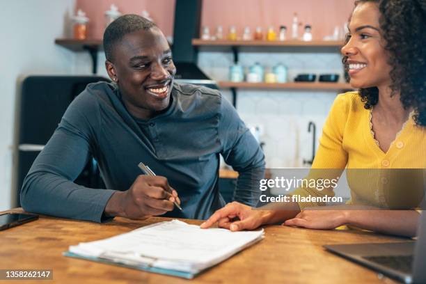 insurance agent - couple signing stock pictures, royalty-free photos & images