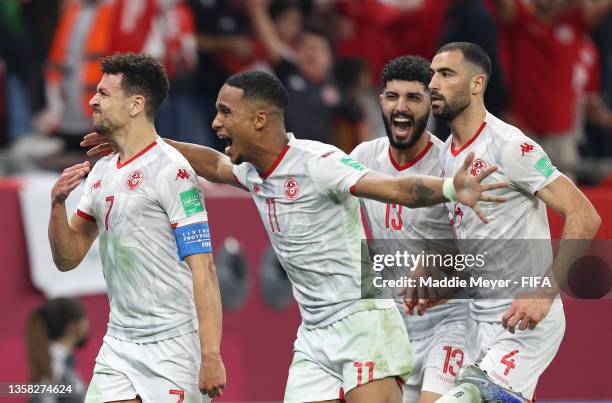 Youssef Msakni of Tunisia celebrates with teammates Seifeddine Jaziri, Ferjani Sassi and Yassine Meriah after scoring their team's second goal during...