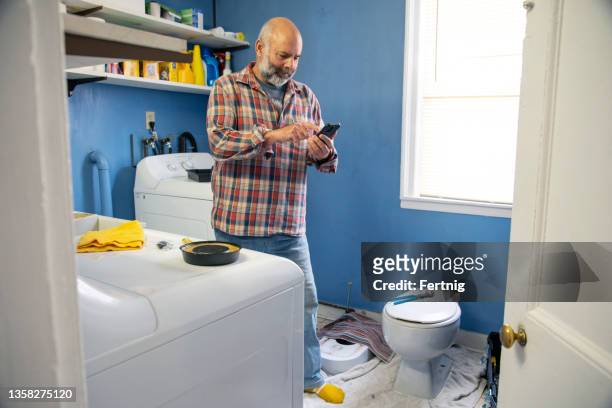 a man shopping online for hardware. - plumber man stockfoto's en -beelden