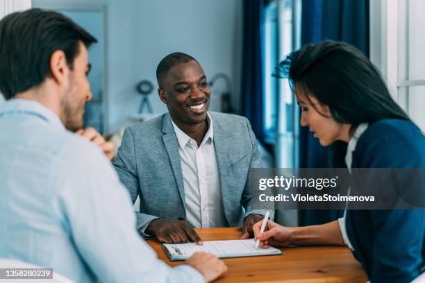 business people signing a contract. - african at the bank stock pictures, royalty-free photos & images